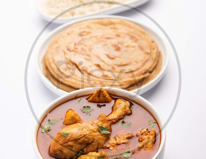 Traditional Indian Chicken Tikka Masala Or Curry Served With Rice And Laccha Paratha Or Roti