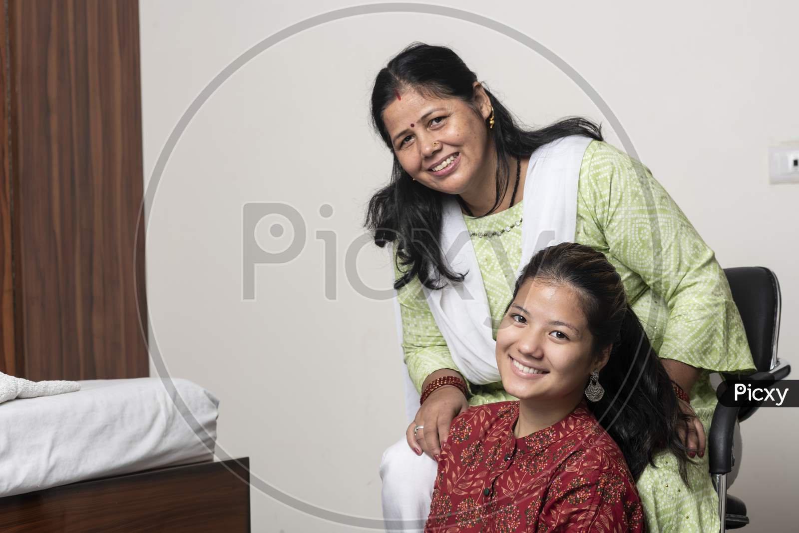 Portrait Of A Young Indian Girl Having Fun With Her Mother, Posing Towards The Camera With Her Mother.