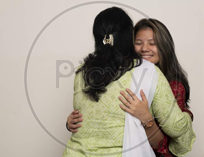 Image of Young Indian Girl Hugging Her Mother With Love, Feeling