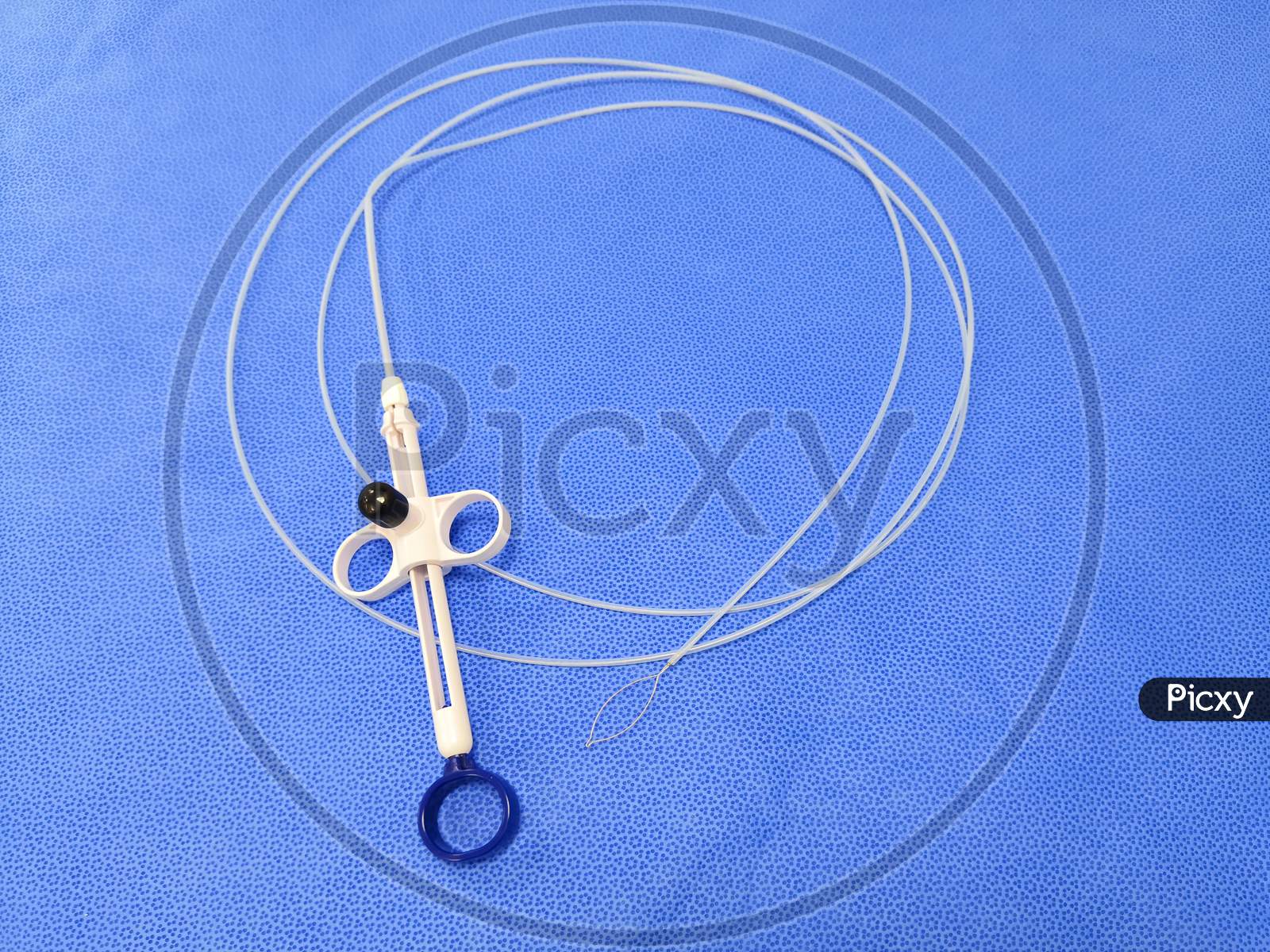 Endoscopic Instrument Polypectomy Snare In Blue Background. Selective Focus