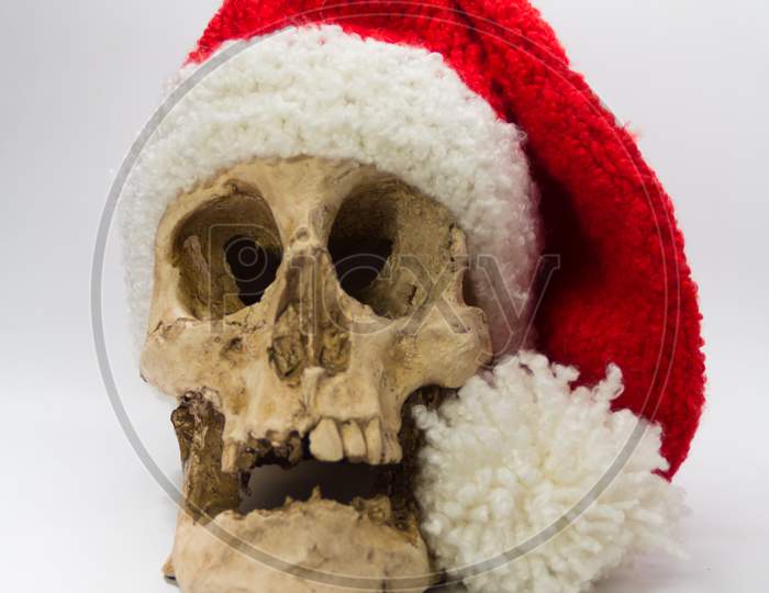 Human Skull With Elf Cap Isolated On Black Background