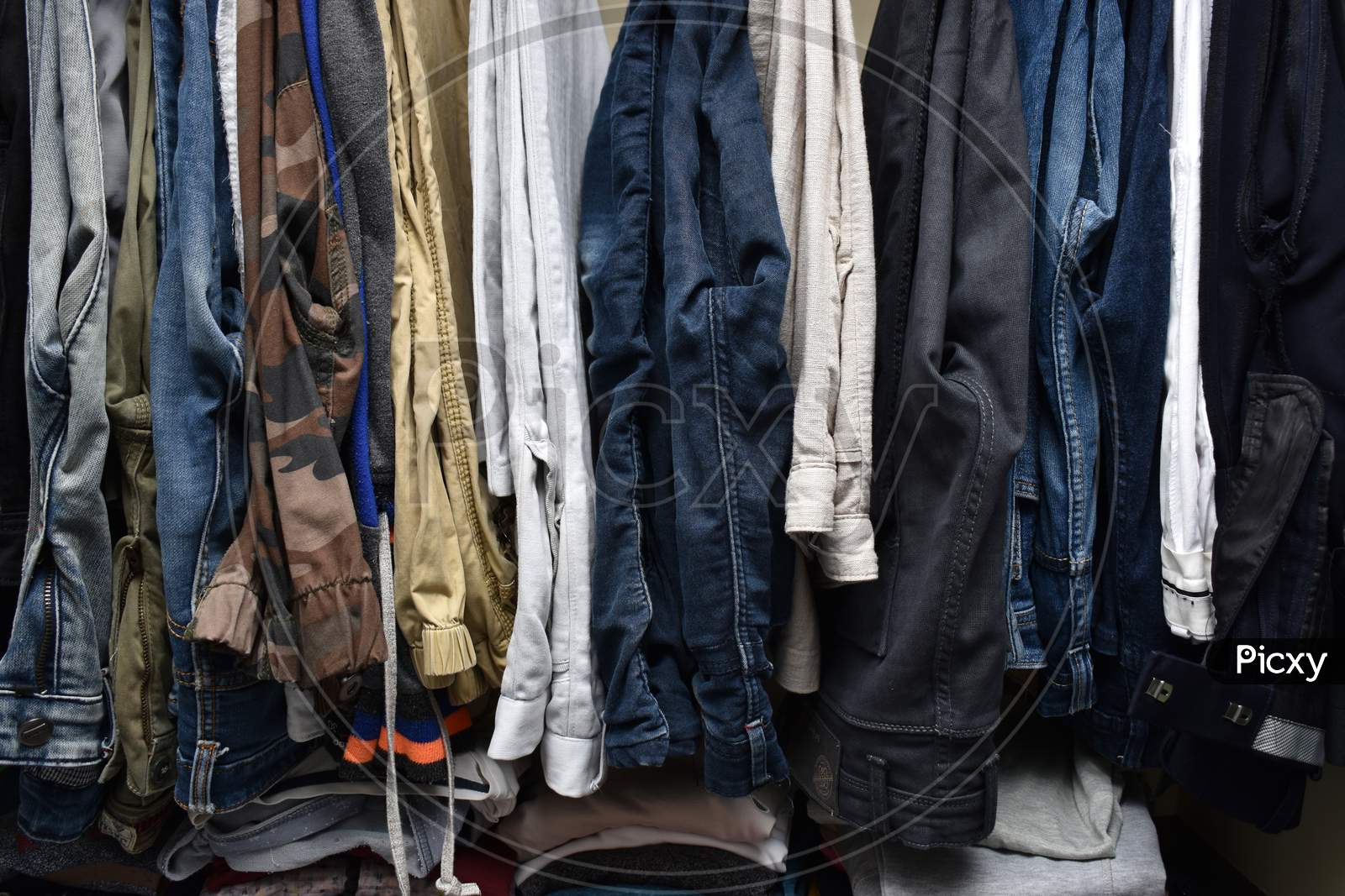 Male Wardrobe Interior View With Clothes Folded And Hung With Hanger