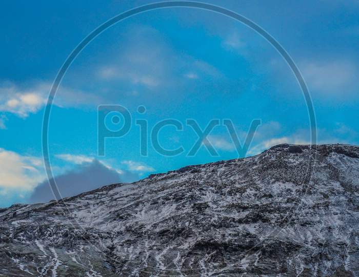 Icelands Snowy Mountain And Blue Sky