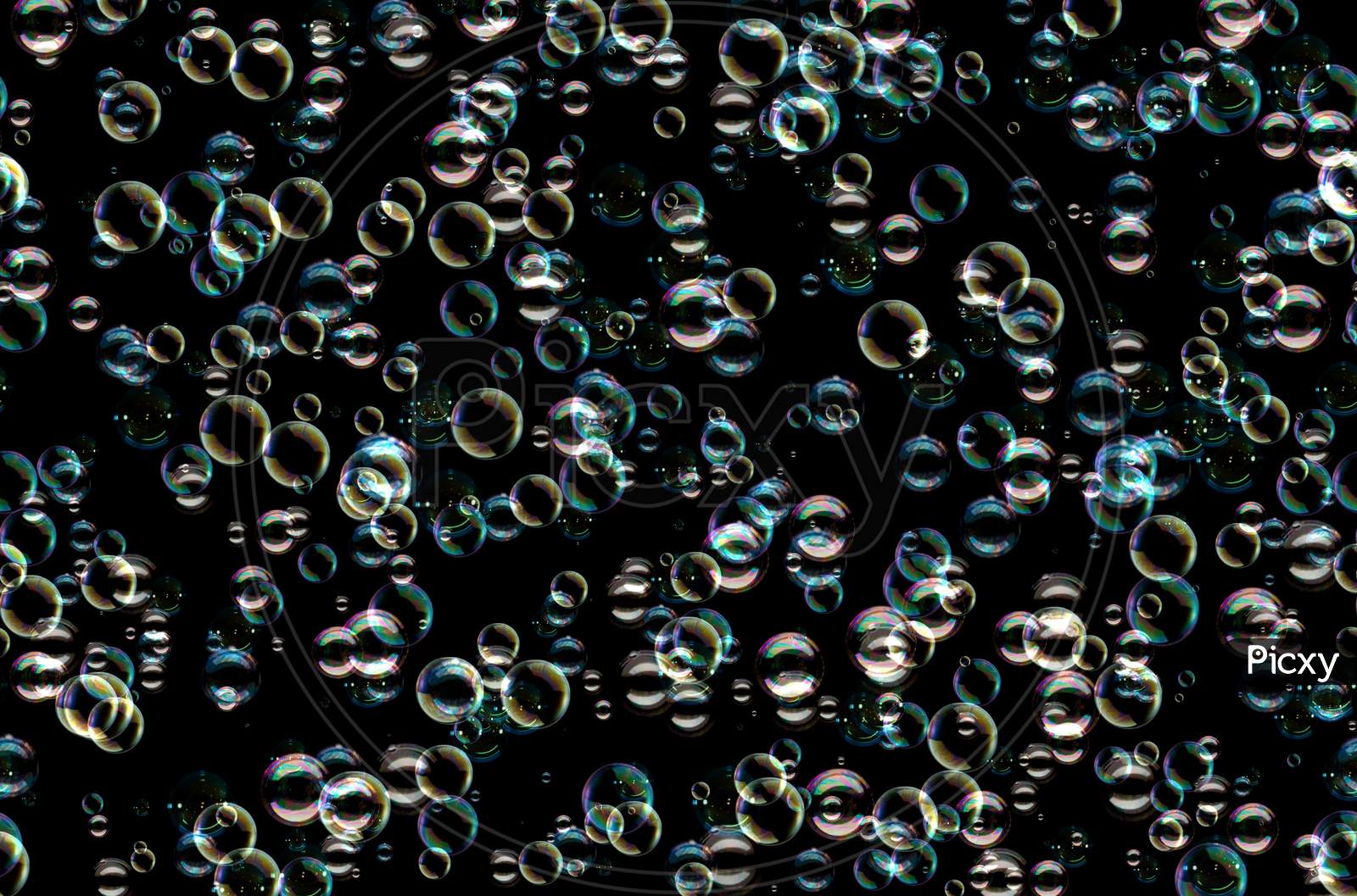 Many Colorful Soap Bubbles On A Black Background. Concept Texture Pattern