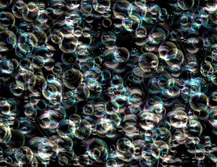 Many Colorful Soap Bubbles On A Black Background. Concept Texture Pattern