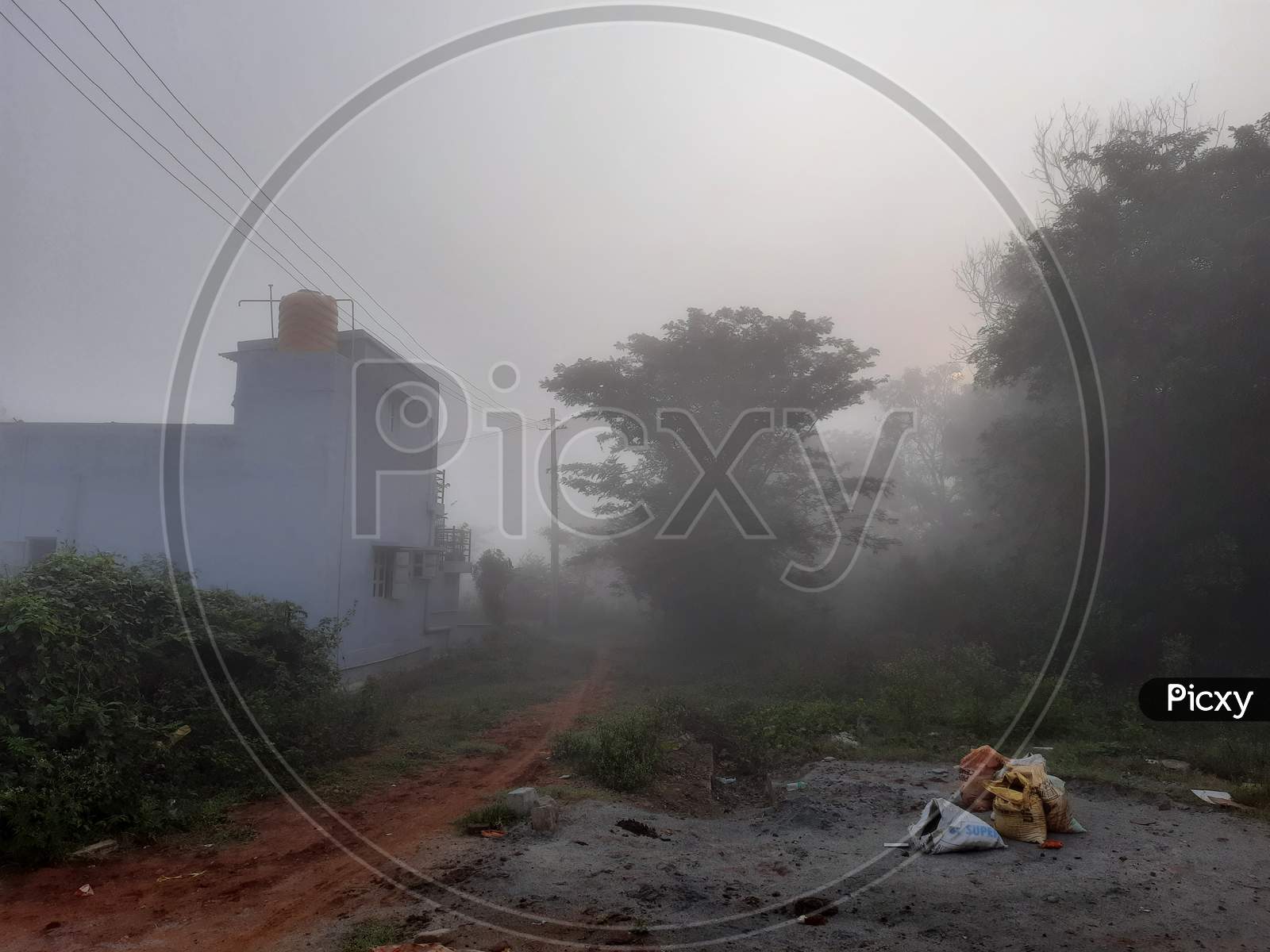 Closeup Of Beautiful View Of Misty Fog In A Rural Baiyandahalli Village, Nature And Building Of Bangalore