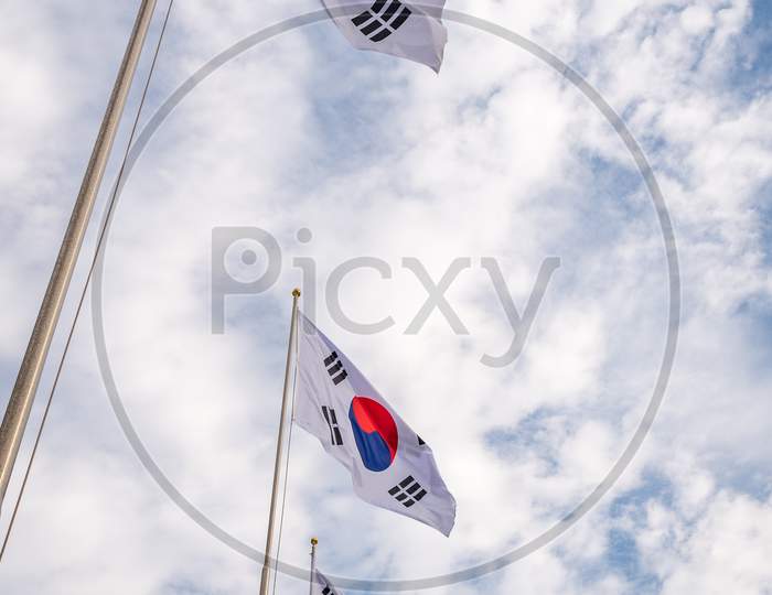 Flags Of South Korea Against The Cloudy Sky