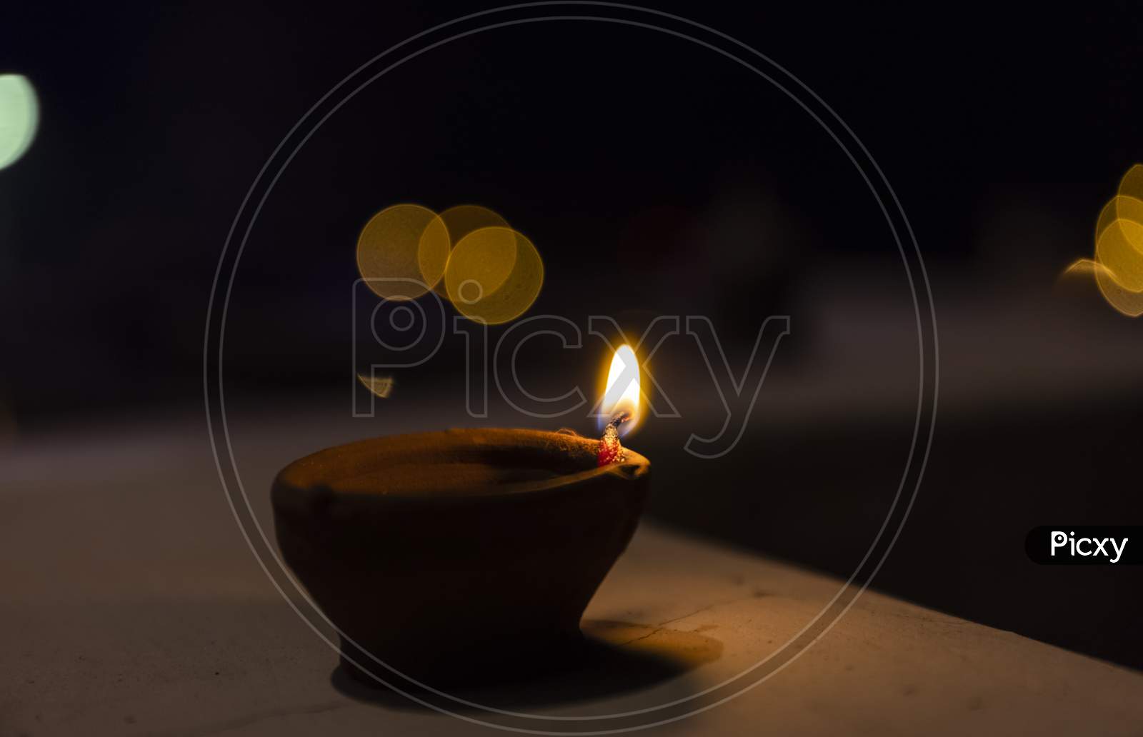 Diya candle light during diwali with colorful blurred background