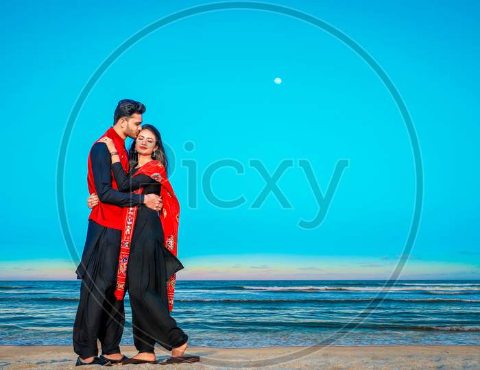 young couple kissing on beach