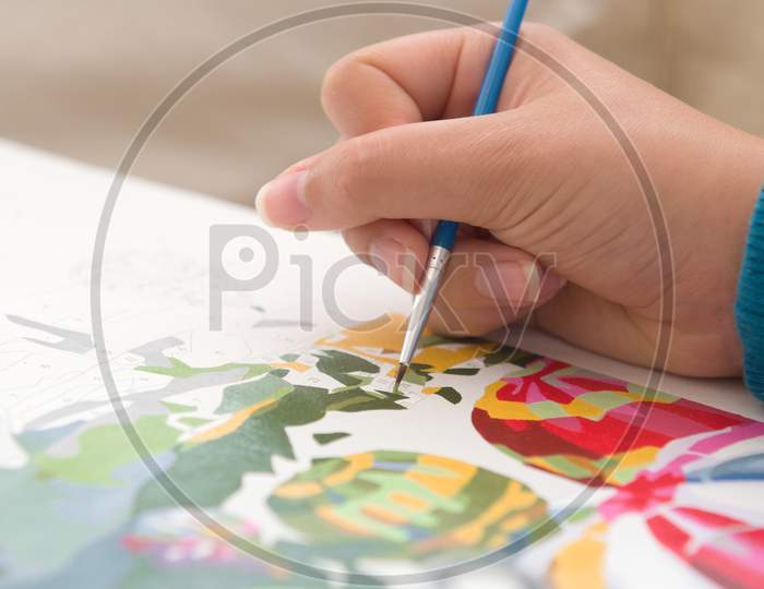 12 - Vertical Image Of Bright Blue Paintbrush Being Used For Painting