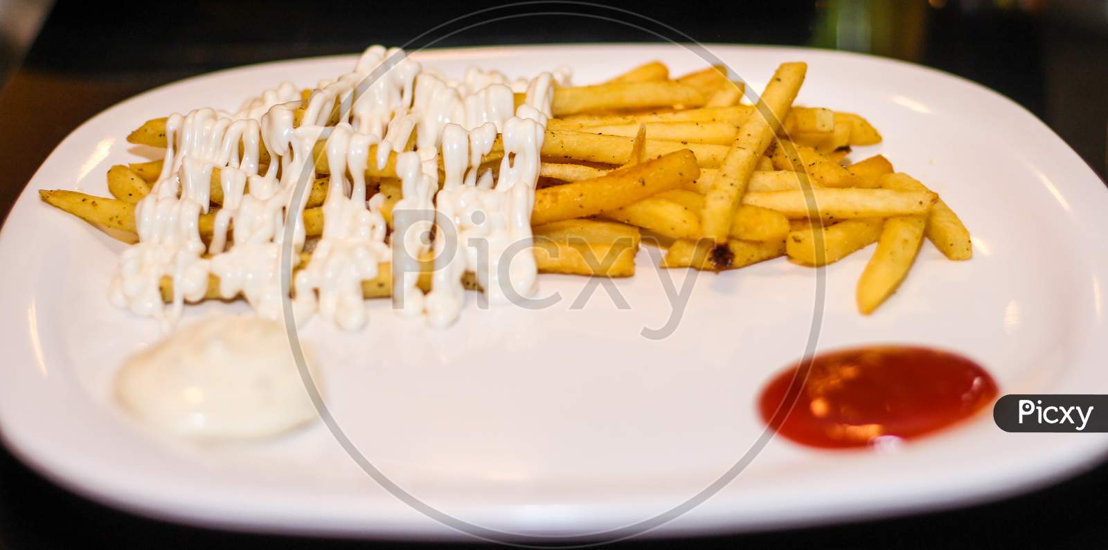 French Fries With Mayonnaise And Tomato Ketchup.
