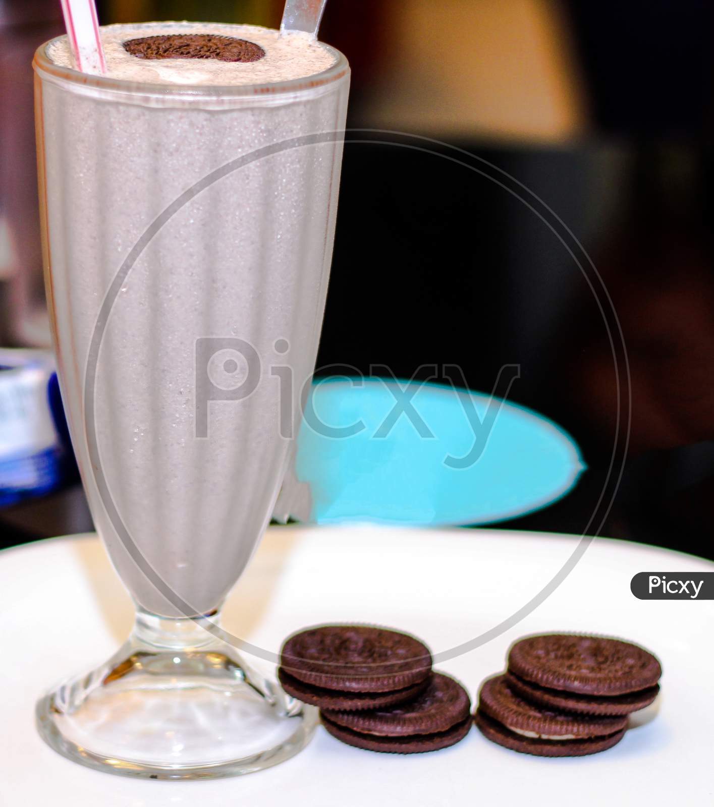 Cold Coffee With Chocolate Cookies With Spread Over White Plate.