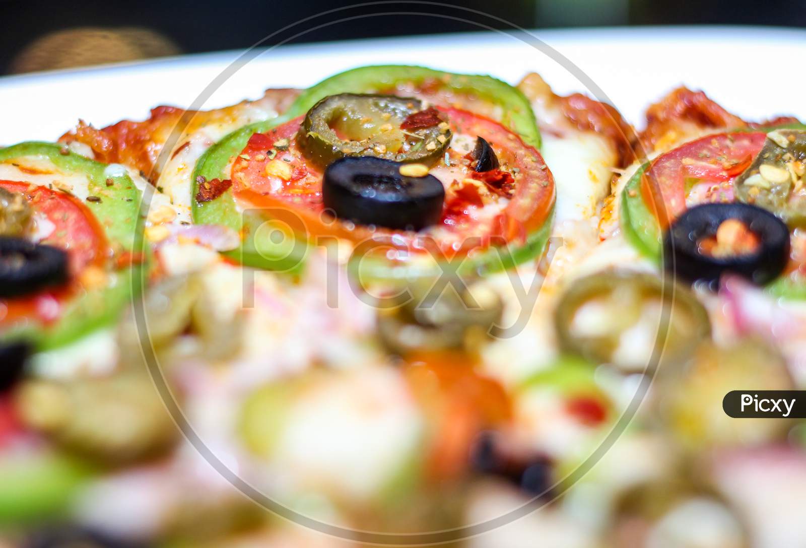 Fresh And Tasty Pizza With Vegetables, Tomato, Onion And Olives Isolated On White Plate. Close View.