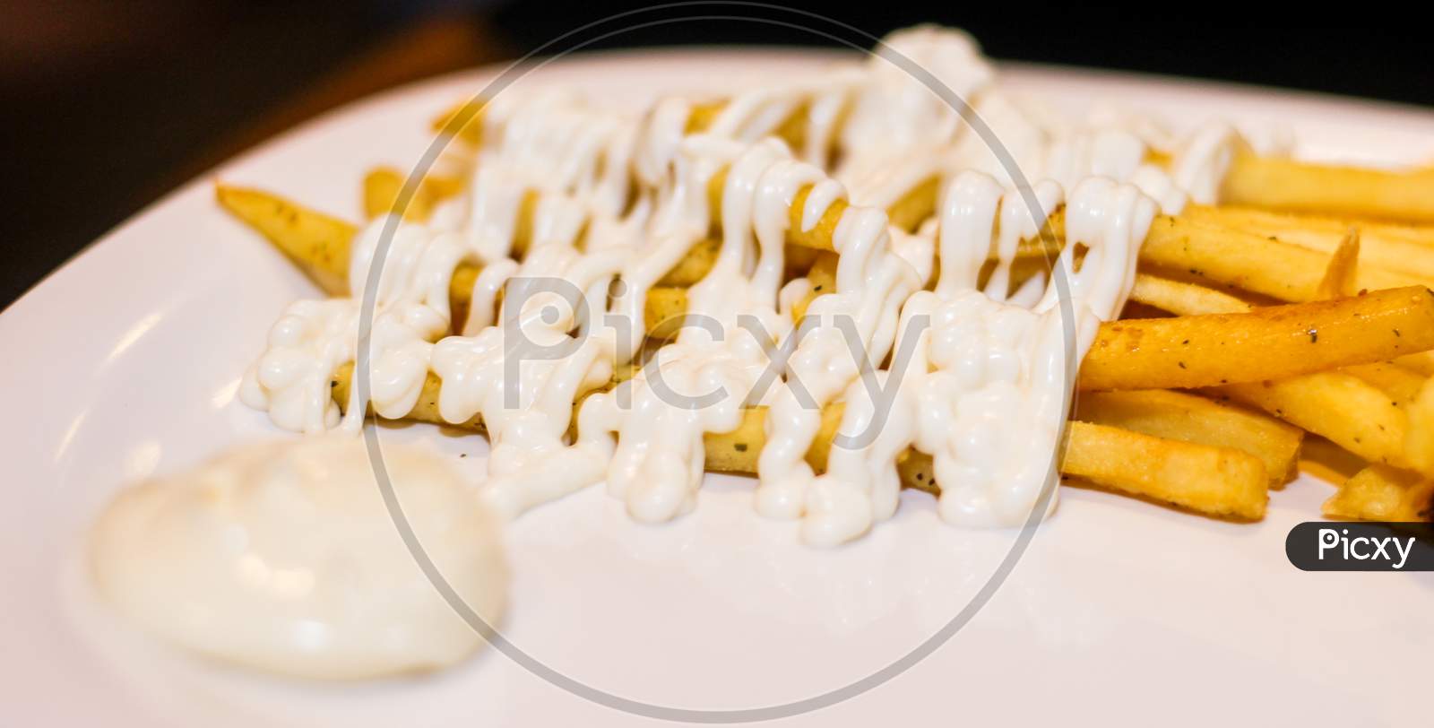 Close Up Of French Fries With Mayonnaise.