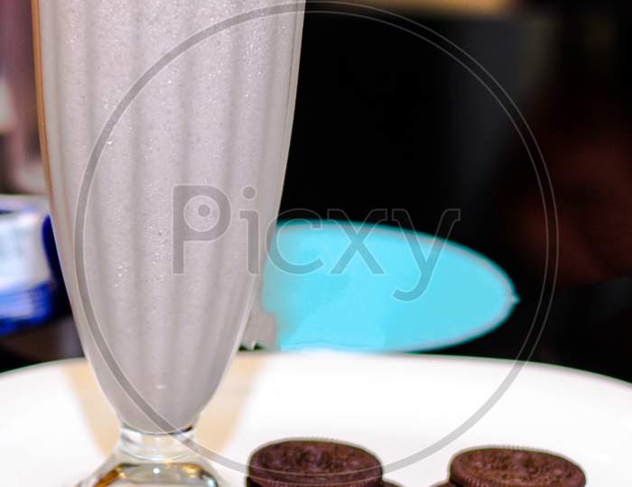 Cold Coffee With Chocolate Cookies With Spread Over White Plate.