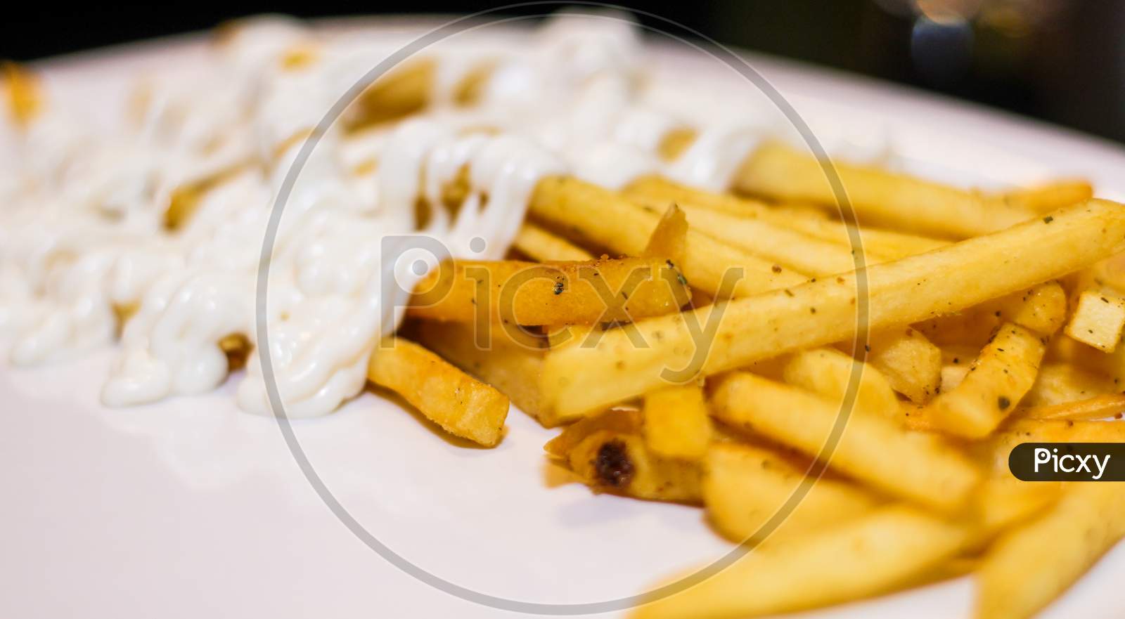 Close Up Of French Fries With Mayonnaise In A Plate.