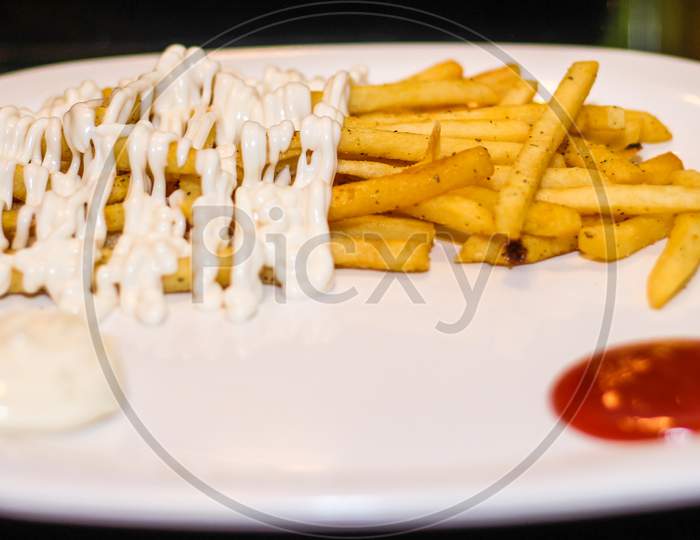 French Fries With Mayonnaise And Tomato Ketchup.