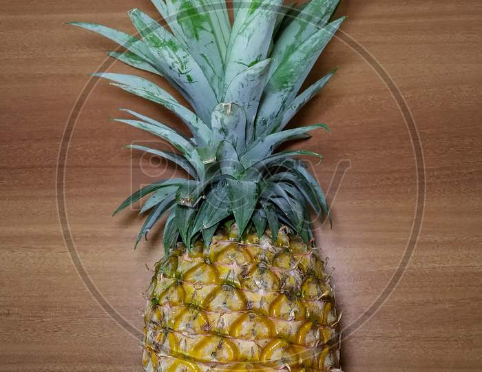 Ripe Pineapple on wooden surface