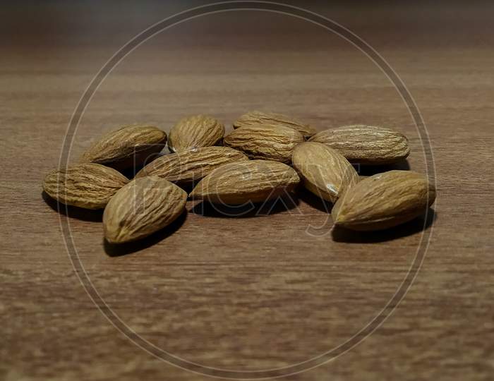 Dry almonds on wooden surface