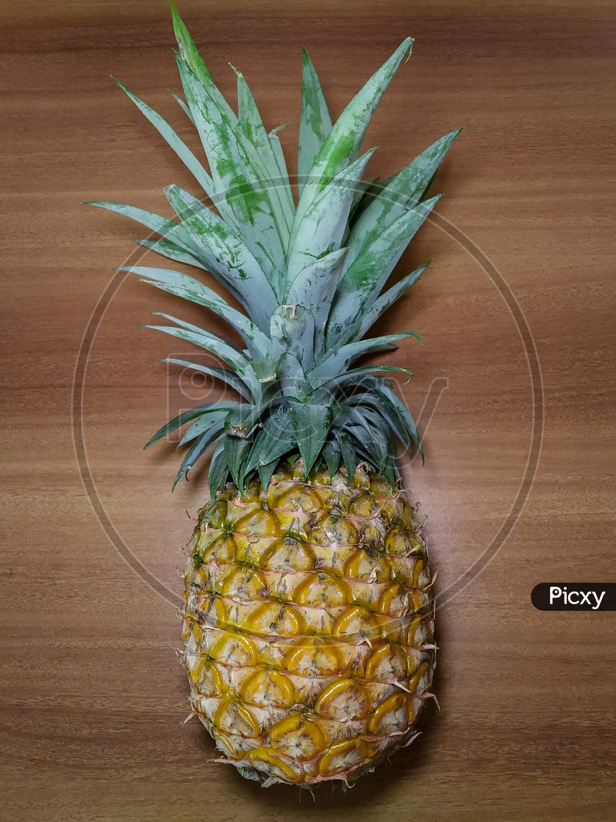 Ripe Pineapple on wooden surface