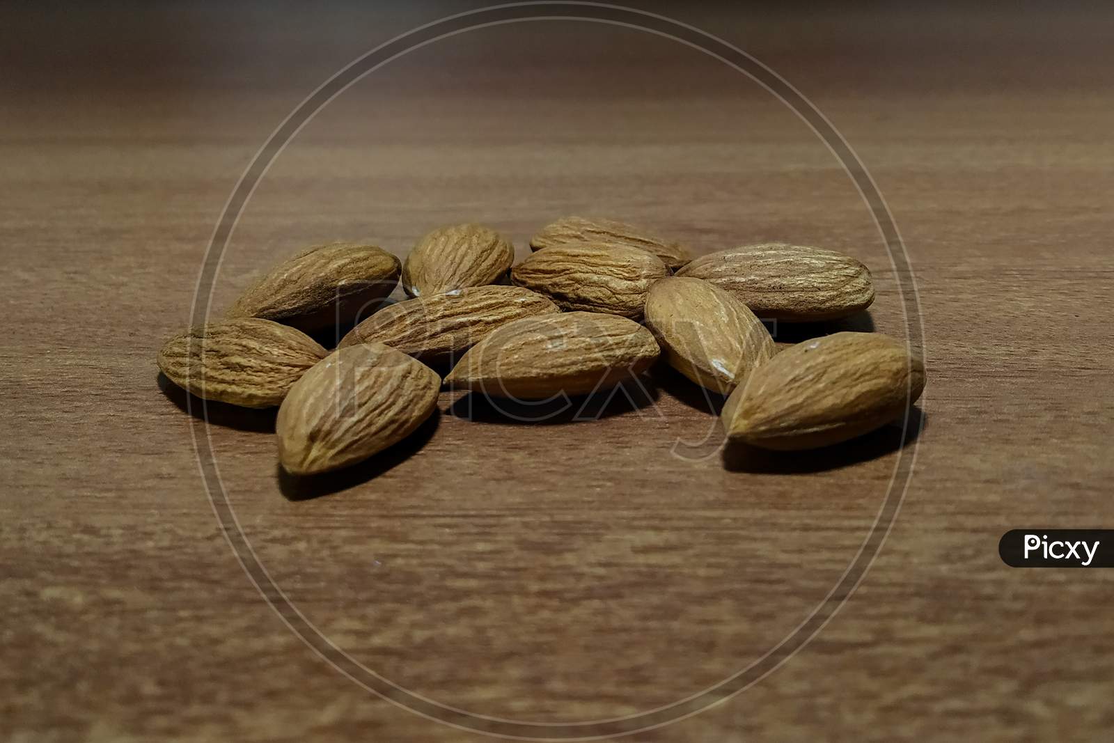 Dry almonds on wooden surface