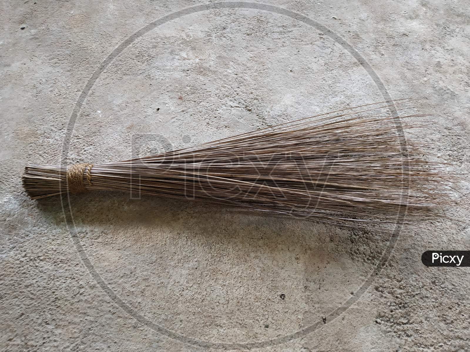 Coconut leaf stick broom for cleaning floors, Maharashtra, India