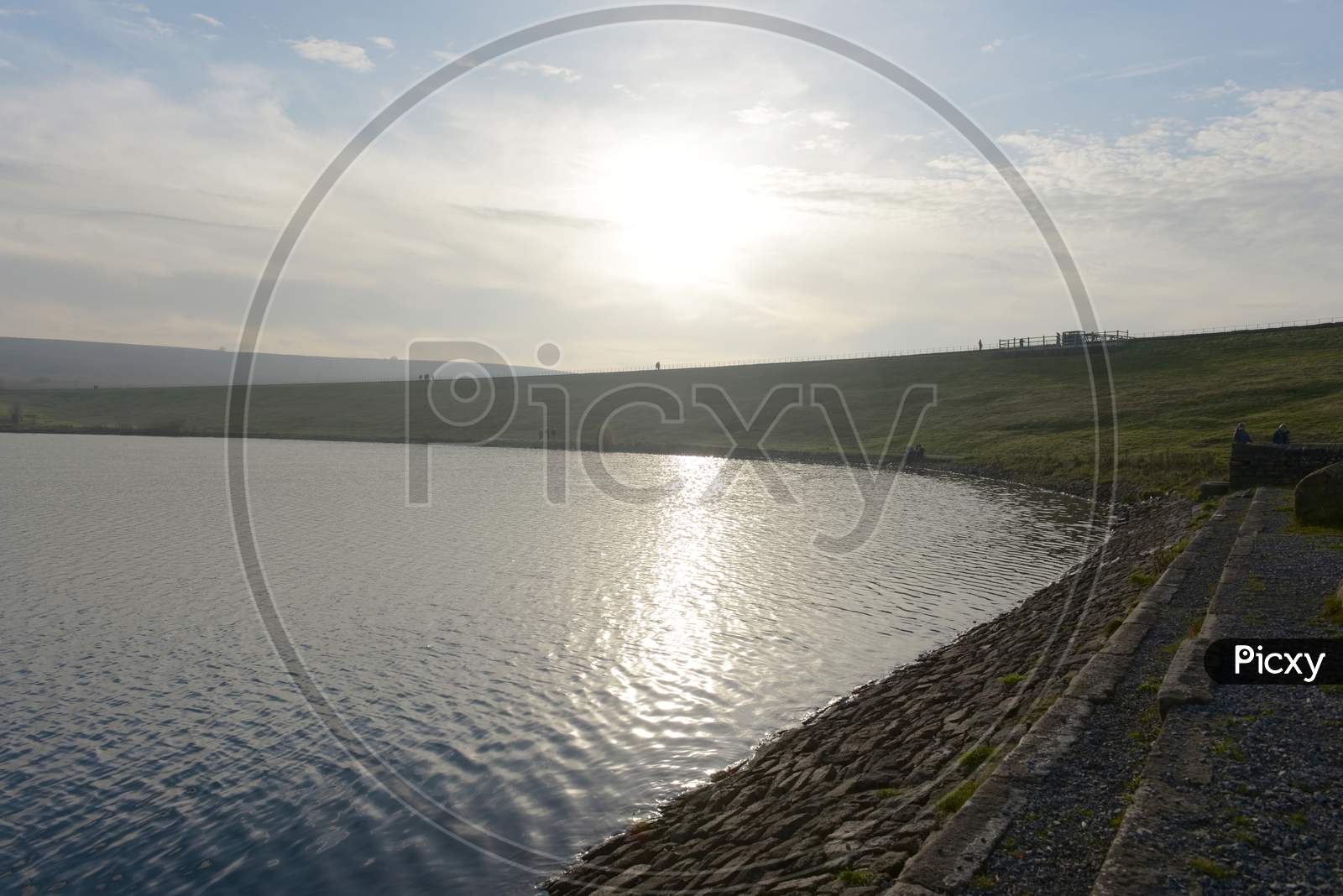 Groups Of People Walk Along The Top Dam At Redmires Reservoirs. Sunny
