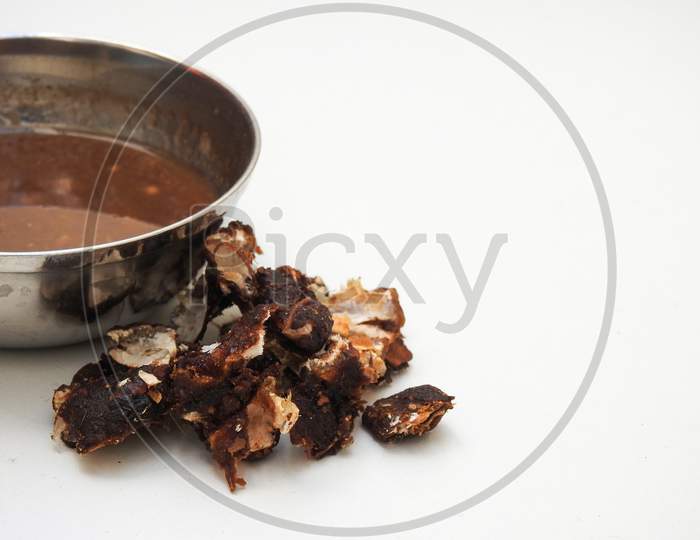Heap Of A Indian Tamarind Fruit And Juice In A Steel Bowl Isolated On White Background
