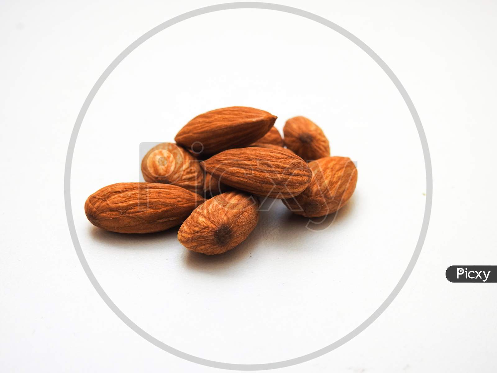 Heap Of A Many Almonds Seeds Isolate On A White Background