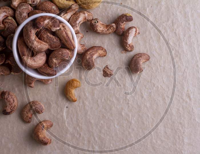 Cashews Isolated On Light Background. Top View. Flat Lay