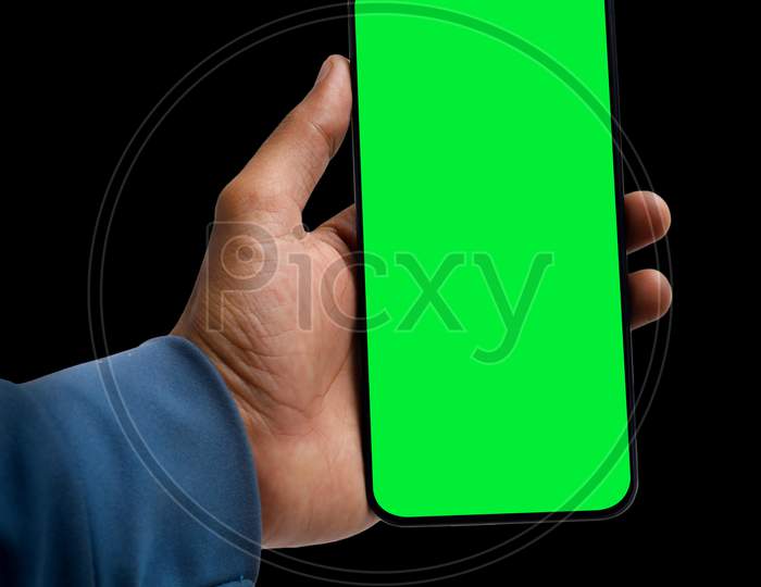 Holding Smartphone In Hand On Dark Background