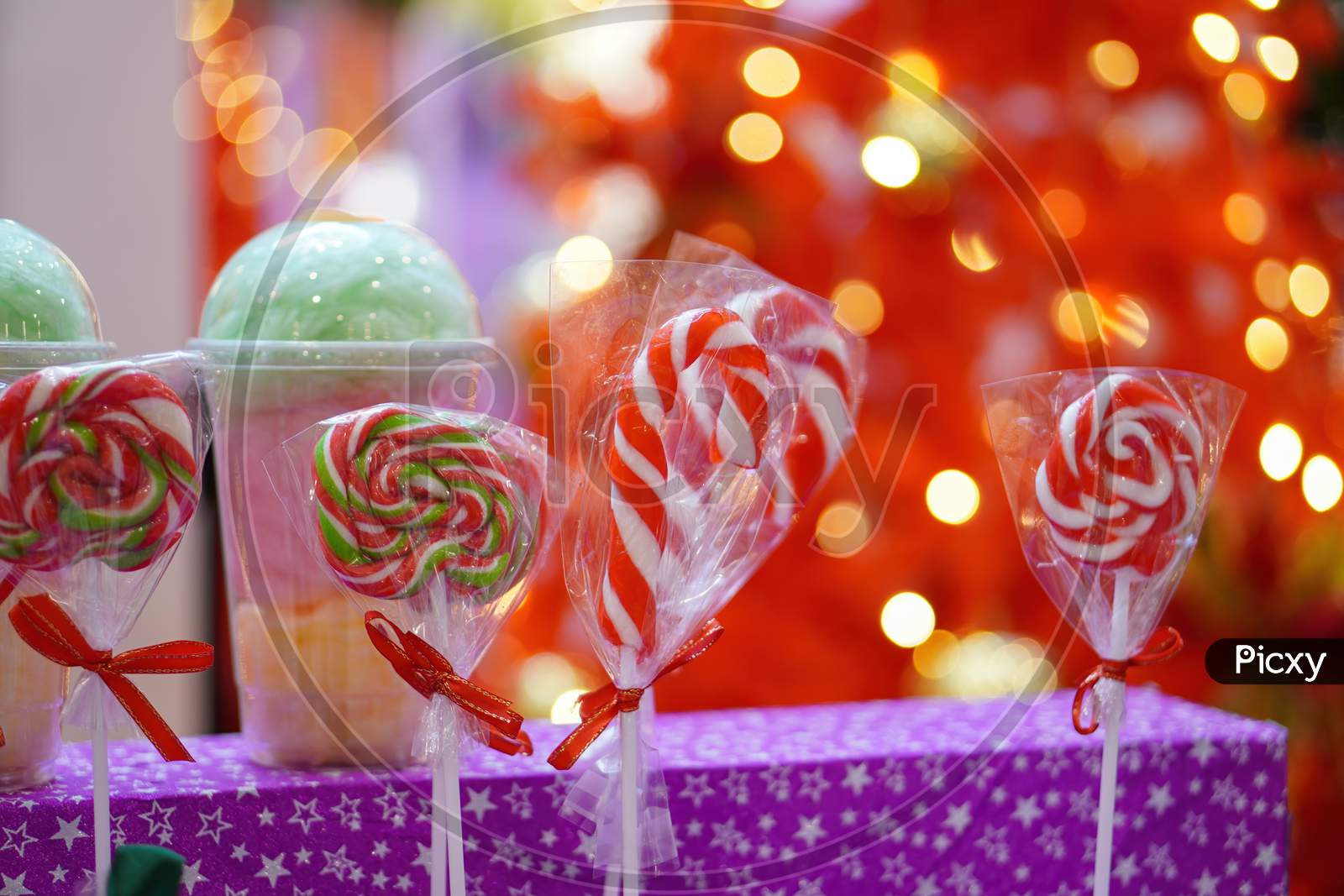 Red And White Christmas Candy And Lollipop With Red Blur Background