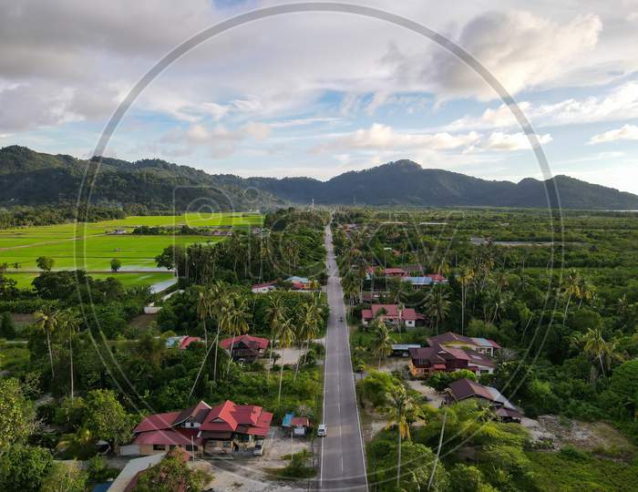 Aerial View Asphalt Road And Rural Malays Kampung House