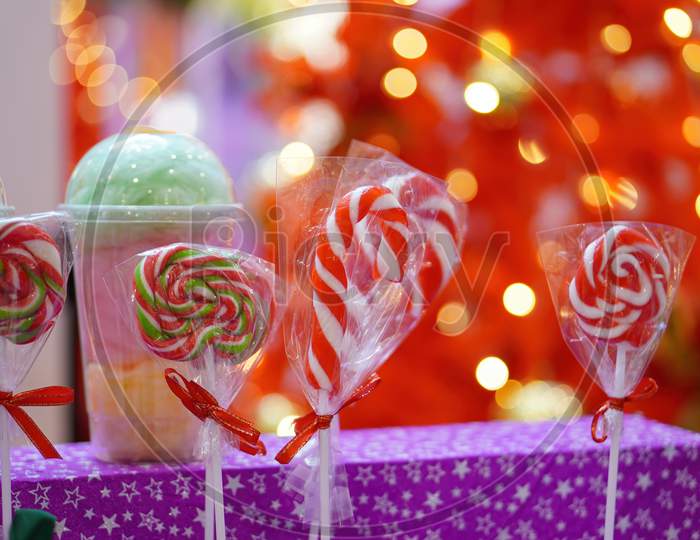 Red And White Christmas Candy And Lollipop With Red Blur Background