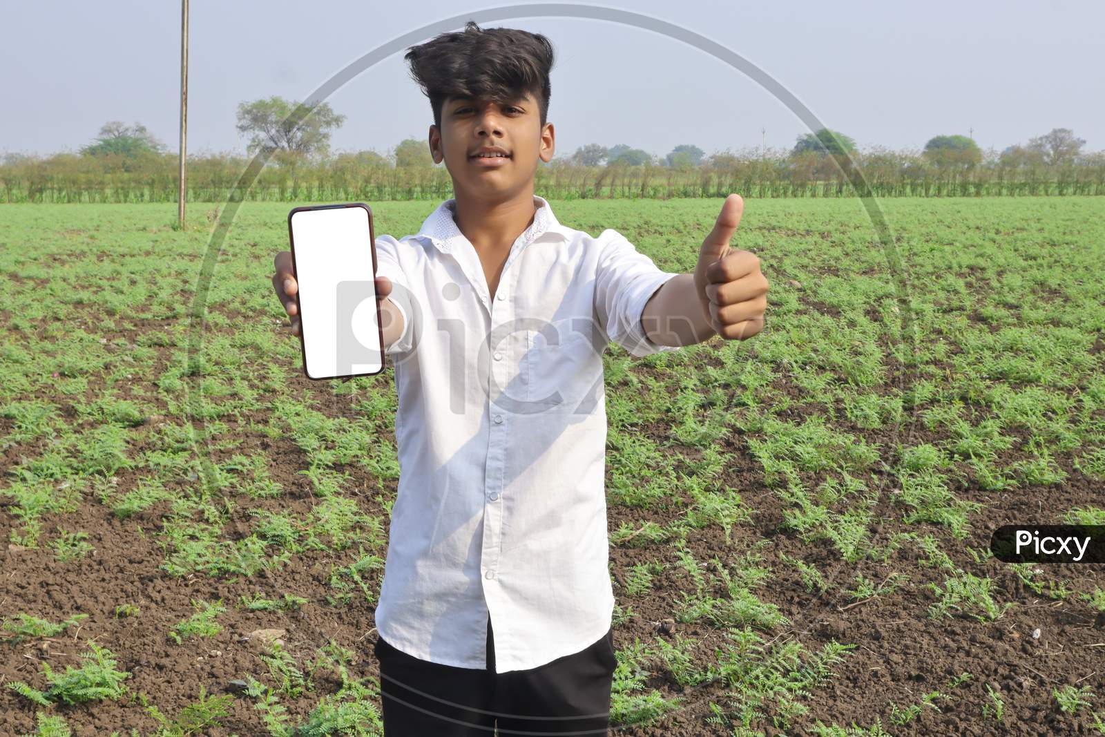 Indian Little Child Showing Smartphone Screen At Agriculture Field.