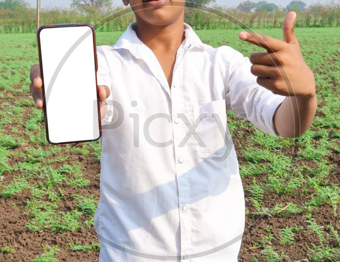 Indian Little Child Showing Smartphone Screen At Agriculture Field.