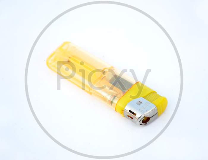 The Yellow Color Plastic Metal Gas Lighter Isolated On White Background.