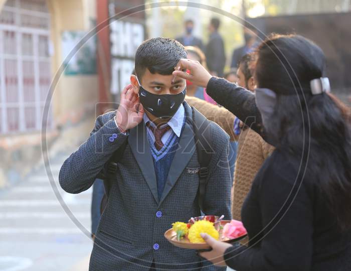 School staff welcome to the students to attend their school in Jammu on Monday. All educational institutions reopened in summer zone Jammu after remaining closed for over 10 months following outbreak of Coronavirus pandemic.1, FEB,2021.