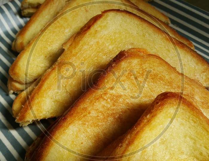 Closeup View Of Freshly Prepared Half Fried Slices Of Toast Bread