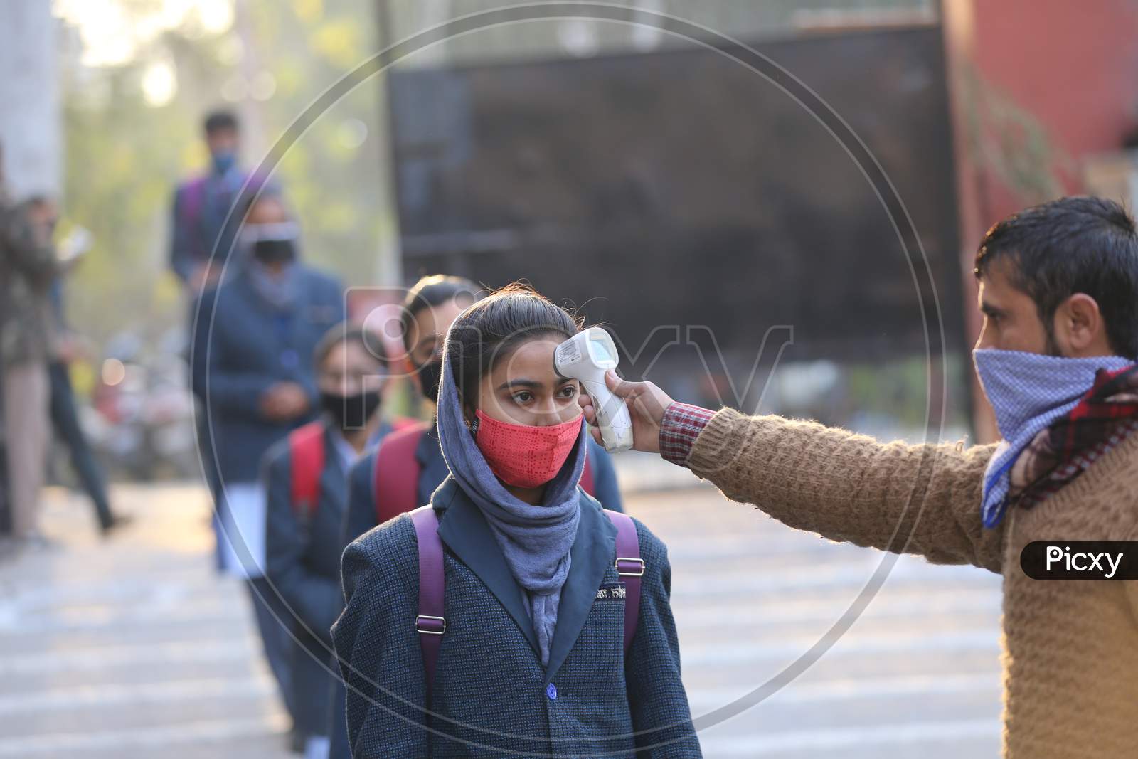 Students getting screened on their arrival in their schools in Jammu on Monday. Most of the educational institutions reopened in summer zone Jammu,1 ,FEB,2021.