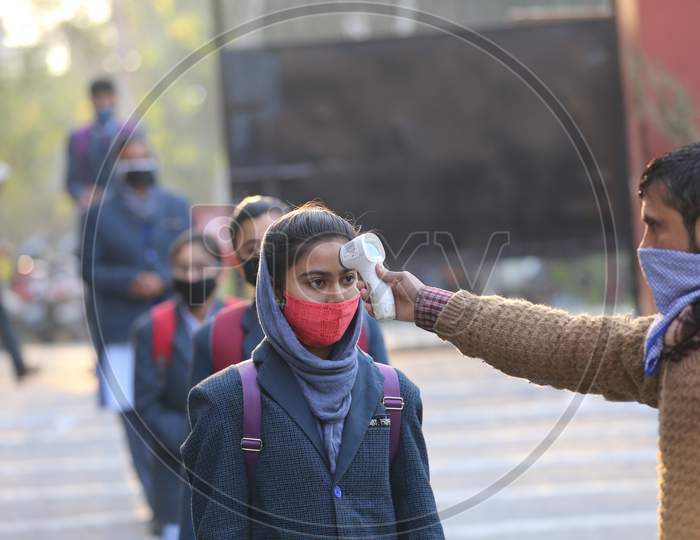 Students getting screened on their arrival in their schools in Jammu on Monday. Most of the educational institutions reopened in summer zone Jammu,1 ,FEB,2021.