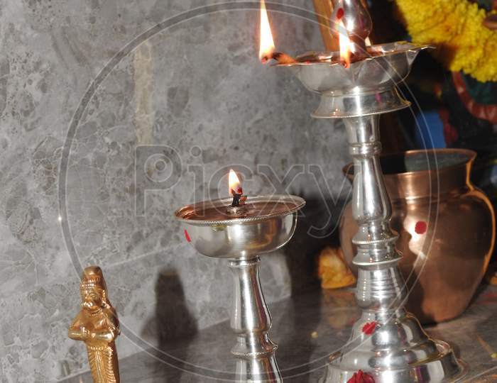 Traditional South Indian Brass Oil Lamp Or Nilavilakku. During Events Like Housewarming, Marriage Etc., The Nilavilakku Is Lighted Before Starting The Rituals