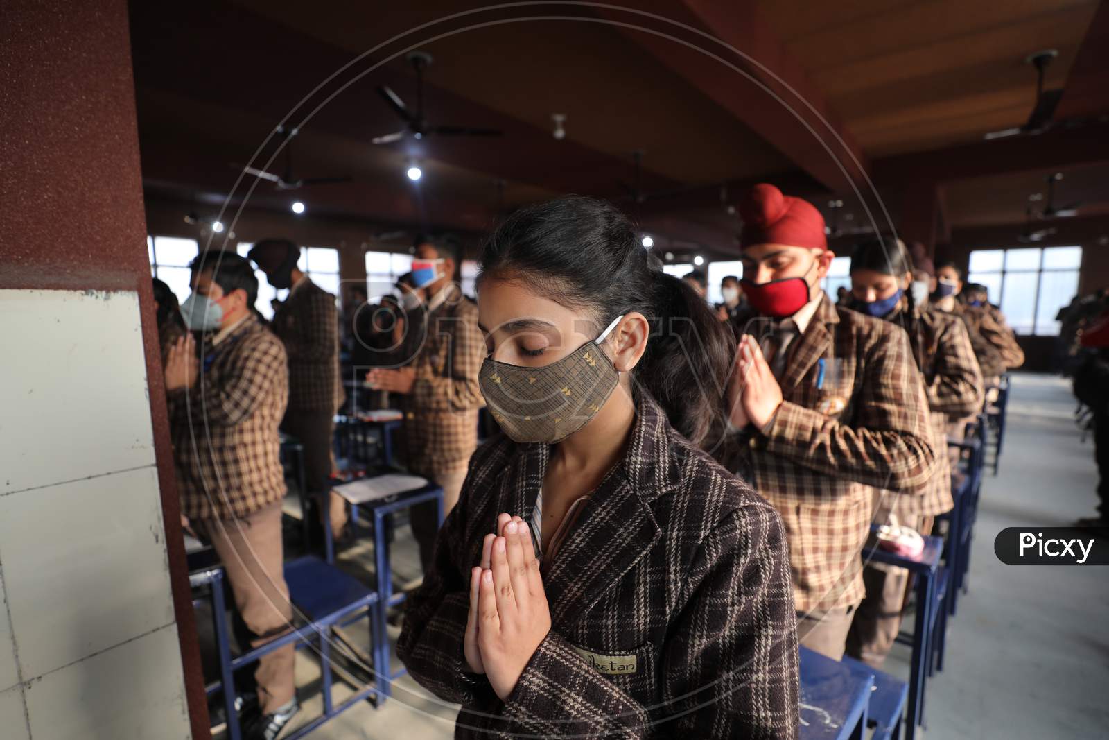 Students offering prayers inside their classroom on the first day of their school in Jammu on Monday. Most of the educational  institutions reopened in summer zone Jammu after remaining closed for over 10 months following outbreak of Coronavirus pandemic.1,FEB,2021.