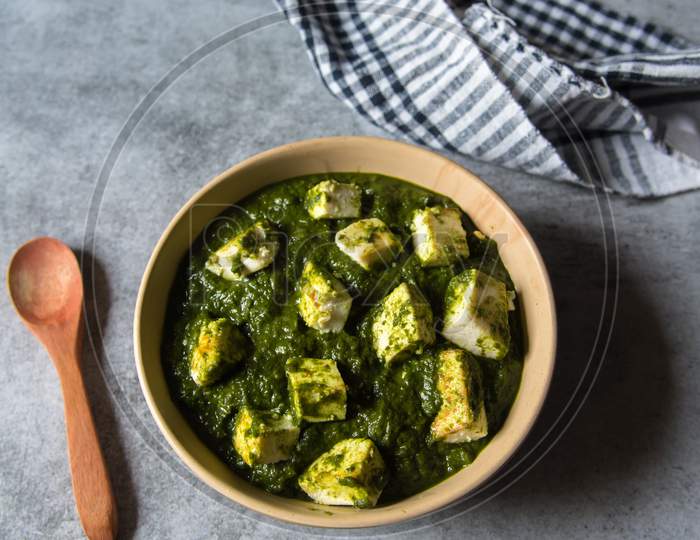 Top view of Palak paneer or cottage cheese cubes in spinach curry