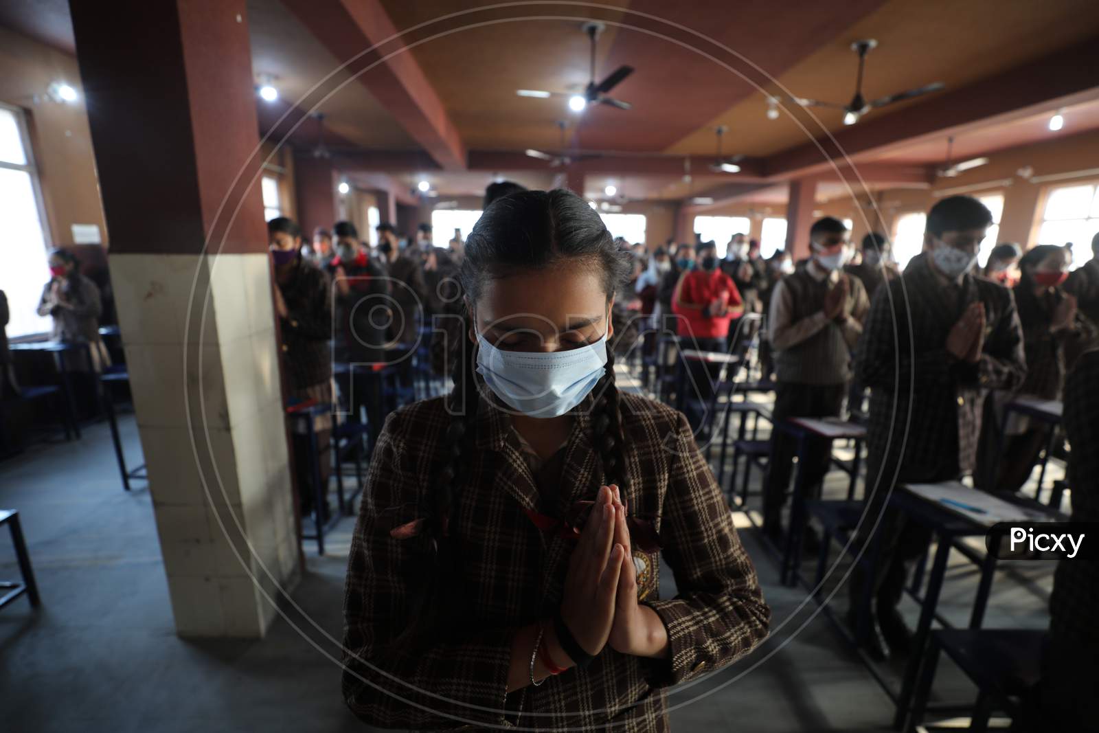 Students offering prayers inside their classroom on the first day of their school in Jammu on Monday. Most of the educational  institutions reopened in summer zone Jammu after remaining closed for over 10 months following outbreak of Coronavirus pandemic.1,FEB,2021.
