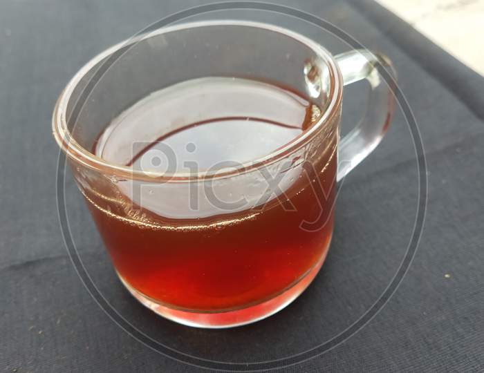 One cup of black tea with black background