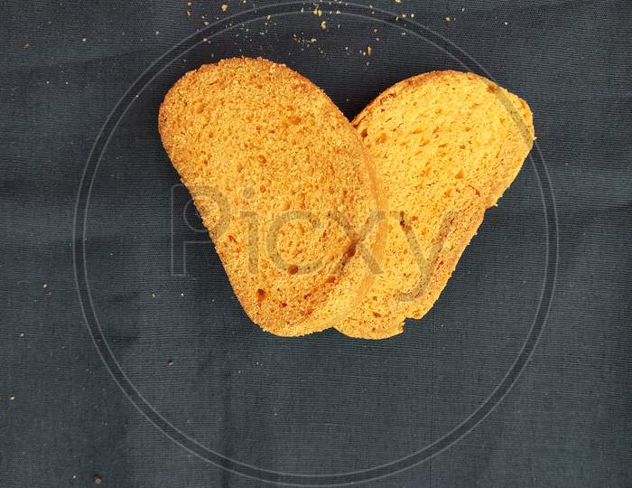 Two yellow and crunchy toast with black background