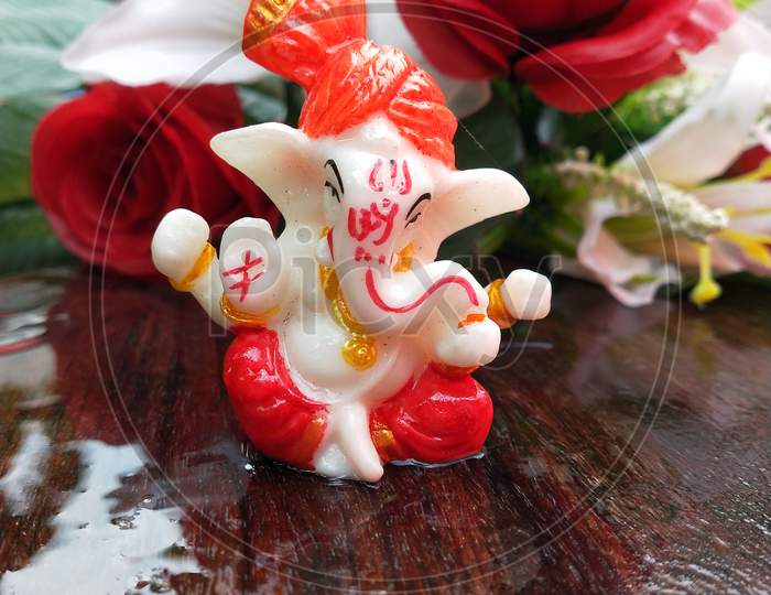 A small lord Ganesha statue with blur background