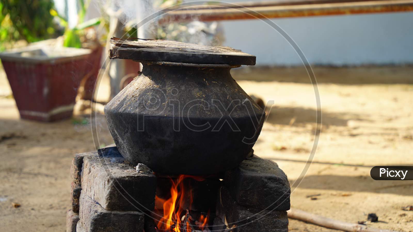 Pottery With Wood Stove On Traditional Kitchen Native Country Of India. Natural Clay Stove Or Brick Stove With Wooden Sticks.