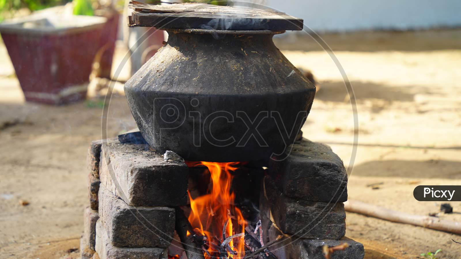 Aluminum Pot On Charcoal Burning Stove, Traditional Indian Charcoal Burning Clay Stove, Isolated On White Background With Clipping Path.